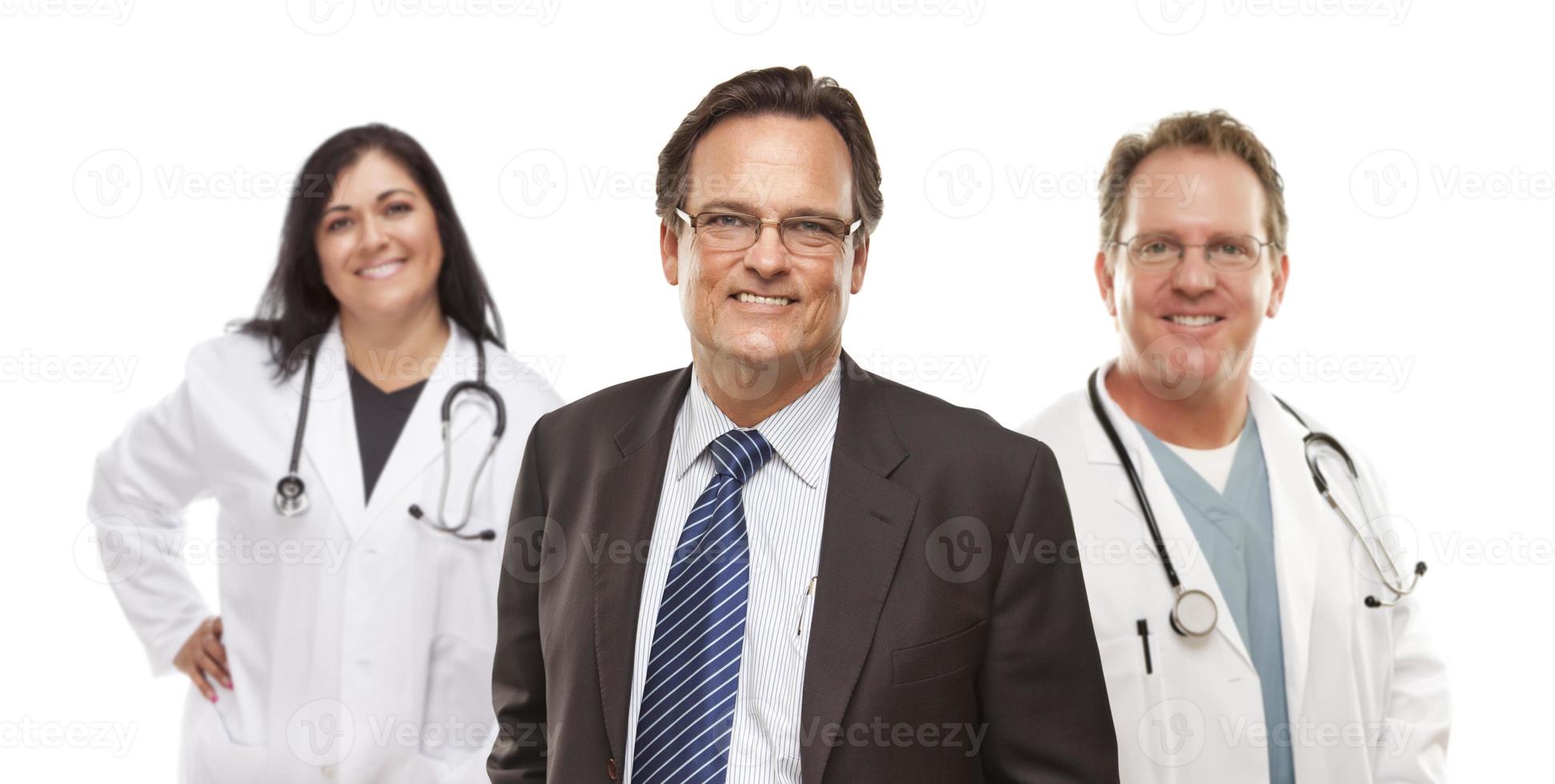 Businessman with Medical Personnel Behind photo