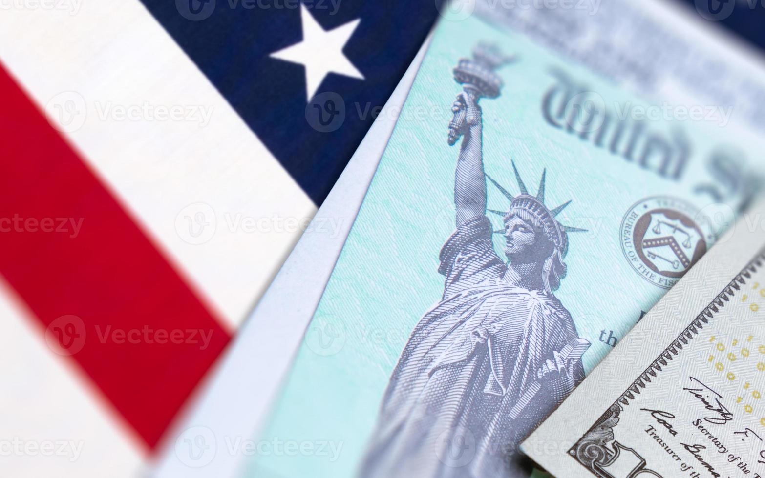 United States IRS Check, Envelope and Money Resting on American Flag photo