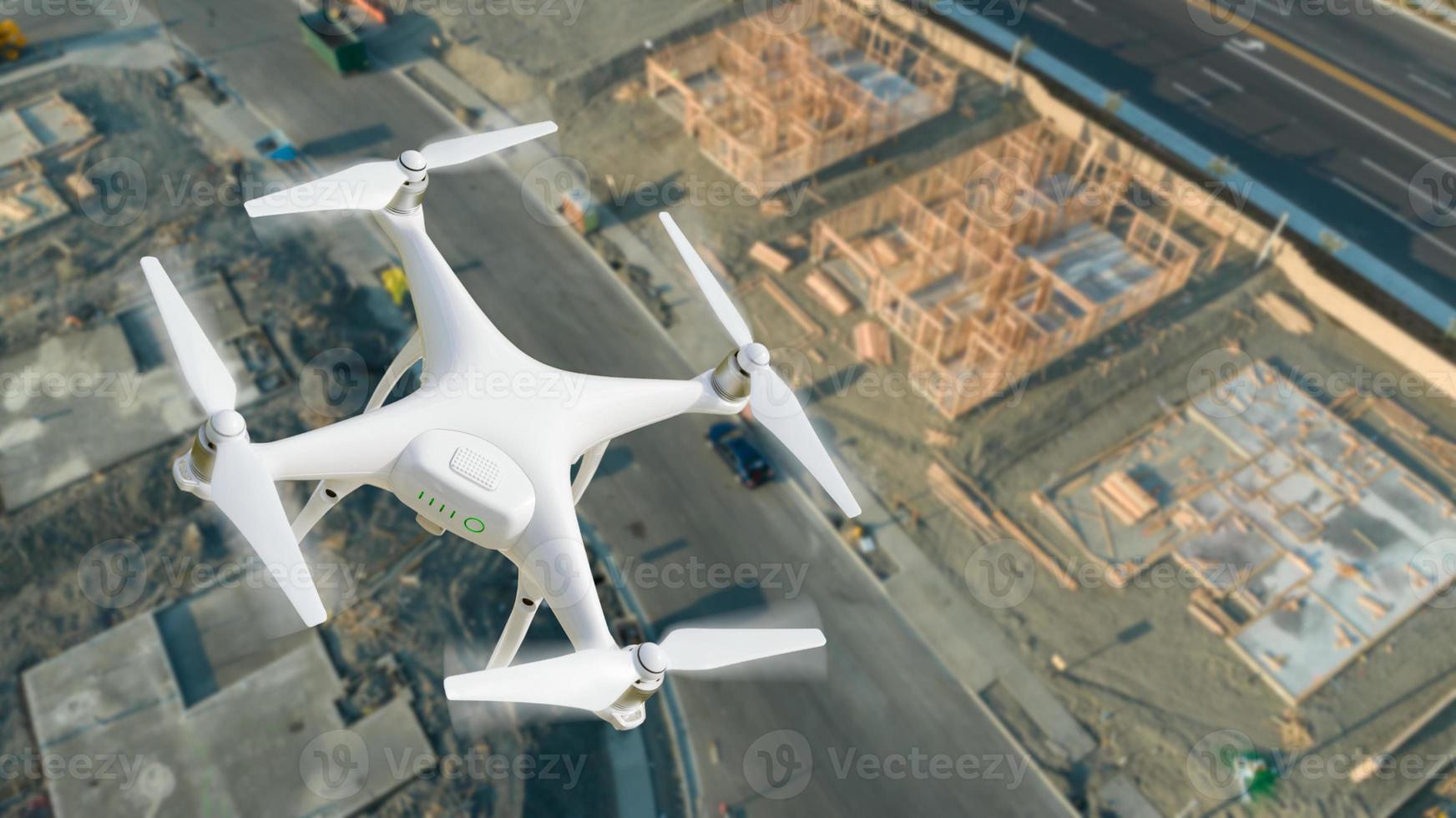 Unmanned Aircraft System UAV Quadcopter Drone In The Air Over Construction Site. photo