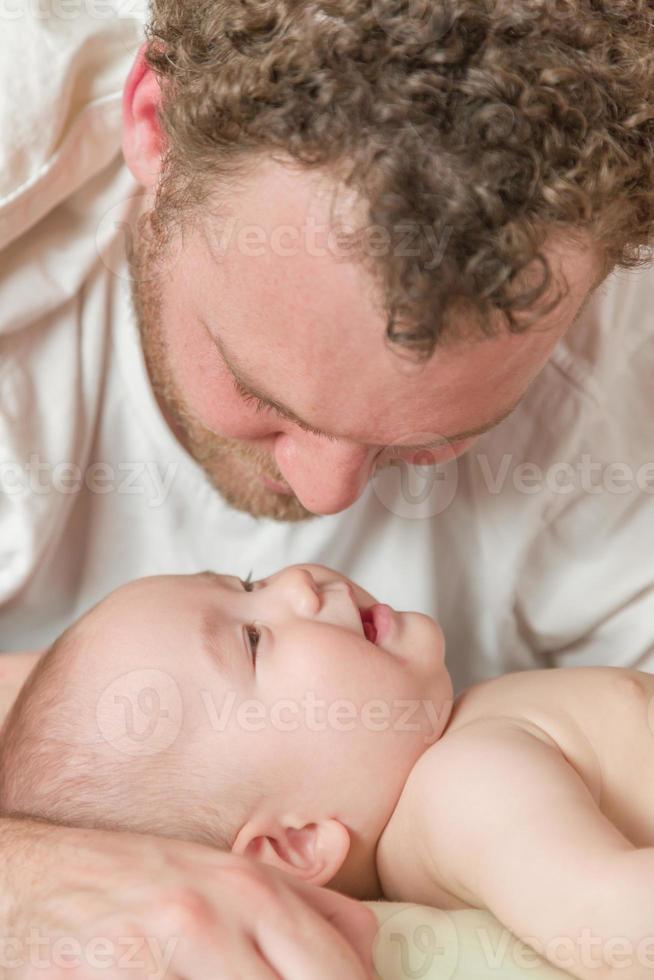Mixed Race Chinese and Caucasian Baby Boy In Bed with His Father photo