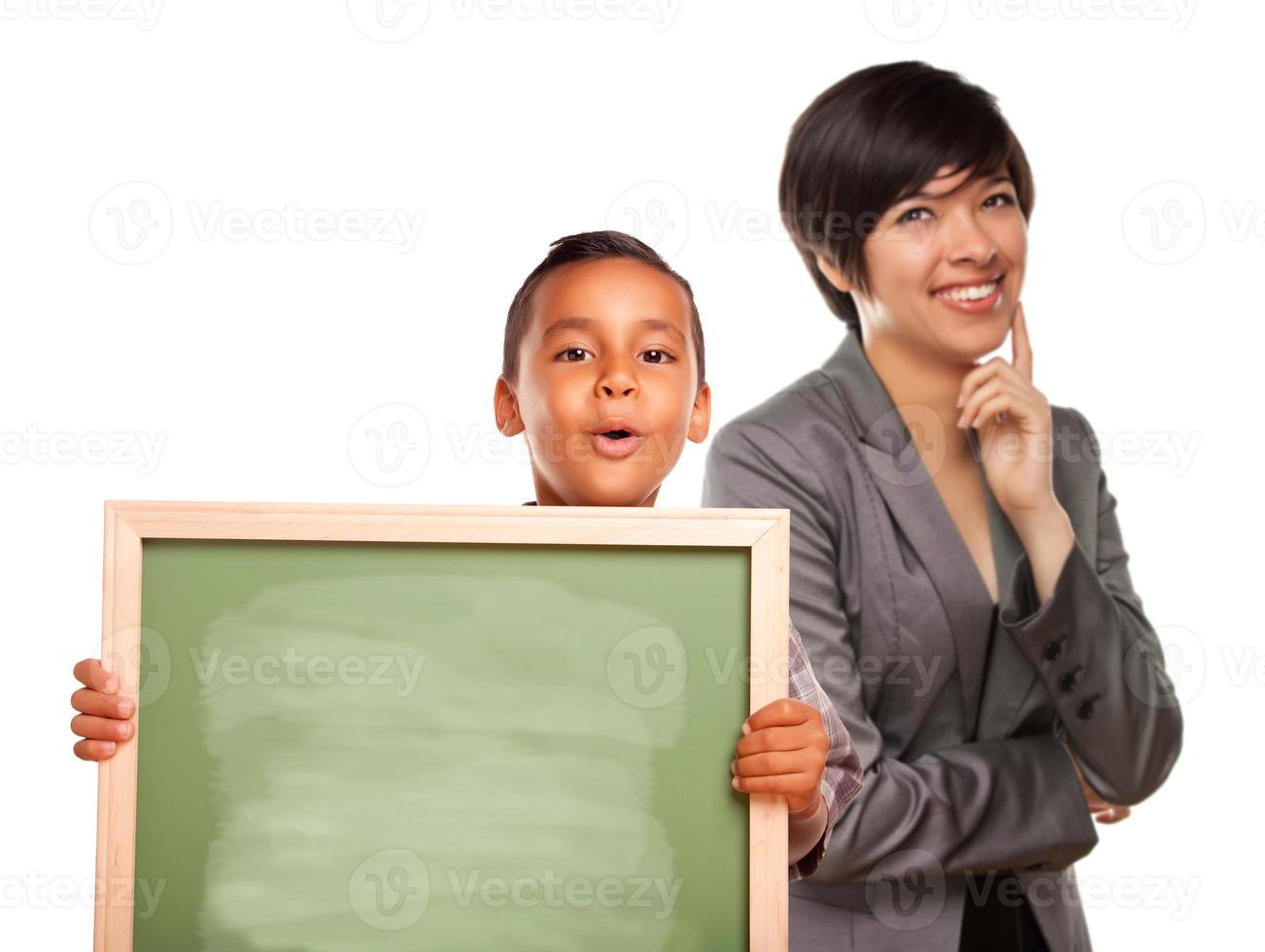 Hispanic Boy Holding Chalk Board and Female Teacher Behind photo