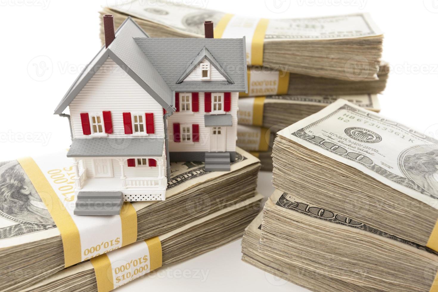 Stacks of Hundreds of Dollars with Small House photo