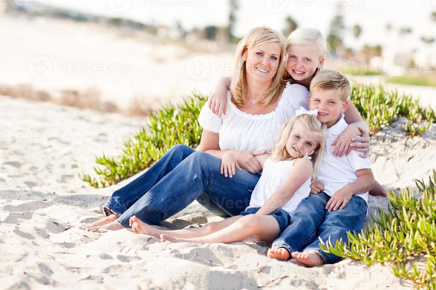 Attractive Mom and Her Cute Children at The Beach photo