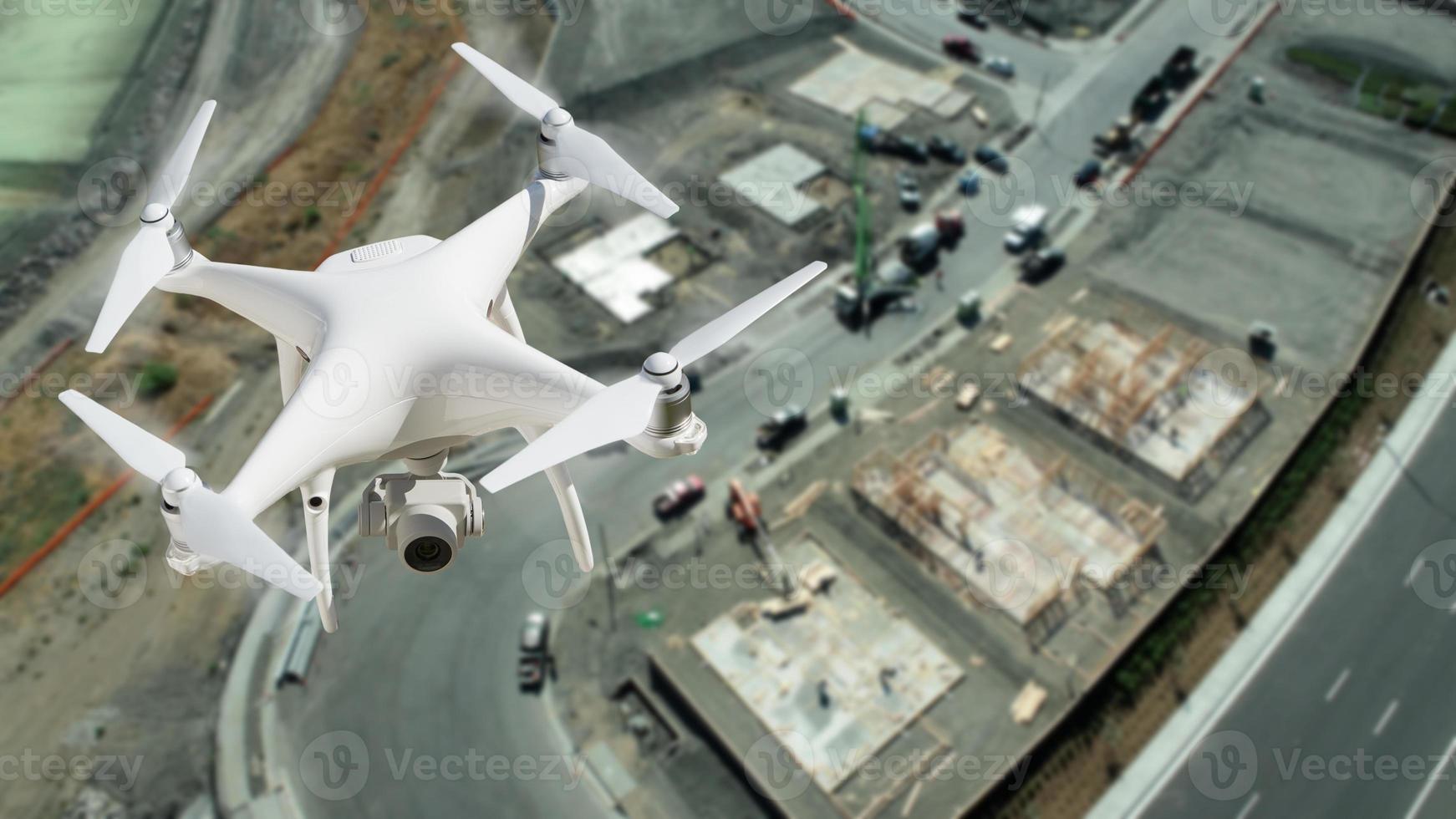 Unmanned Aircraft System UAV Quadcopter Drone In The Air Over Construction Site. photo