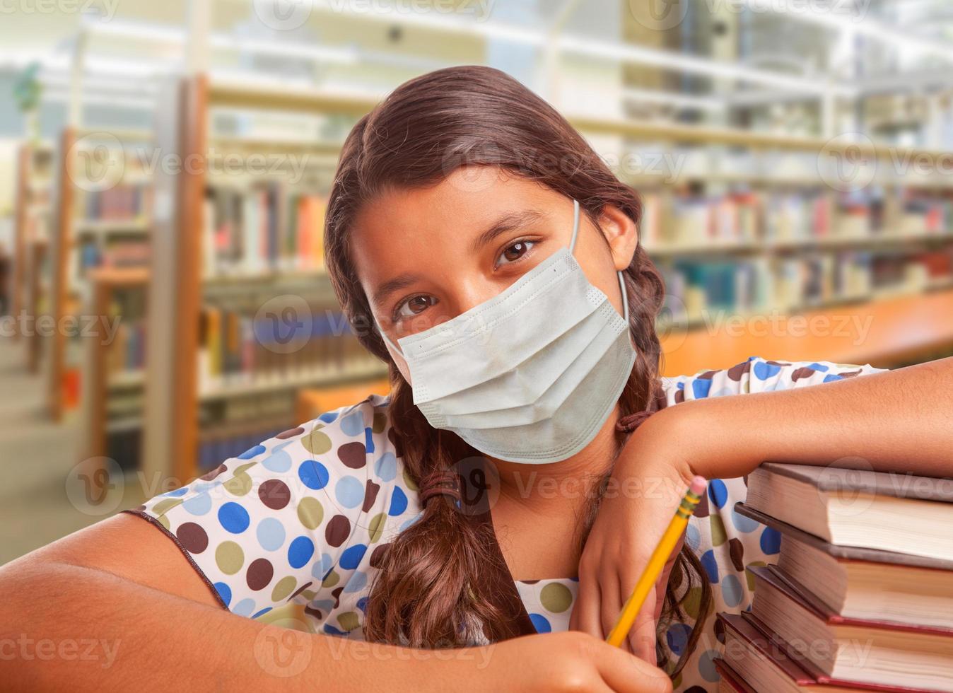 Hispanic Girl Student Wearing Face Mask Studying in Library photo