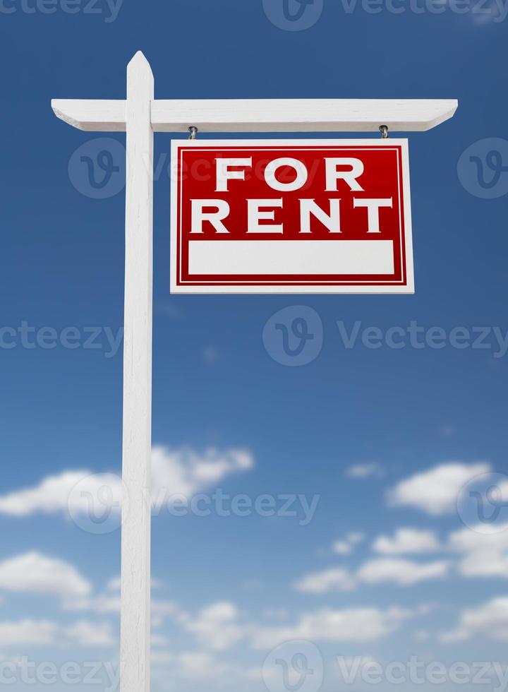 Right Facing For Rent Real Estate Sign on a Blue Sky with Clouds. photo