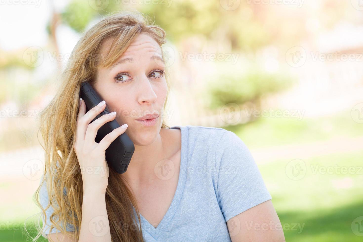 Young Adult Woman Outdoors Talking on Her Smart Phone. photo