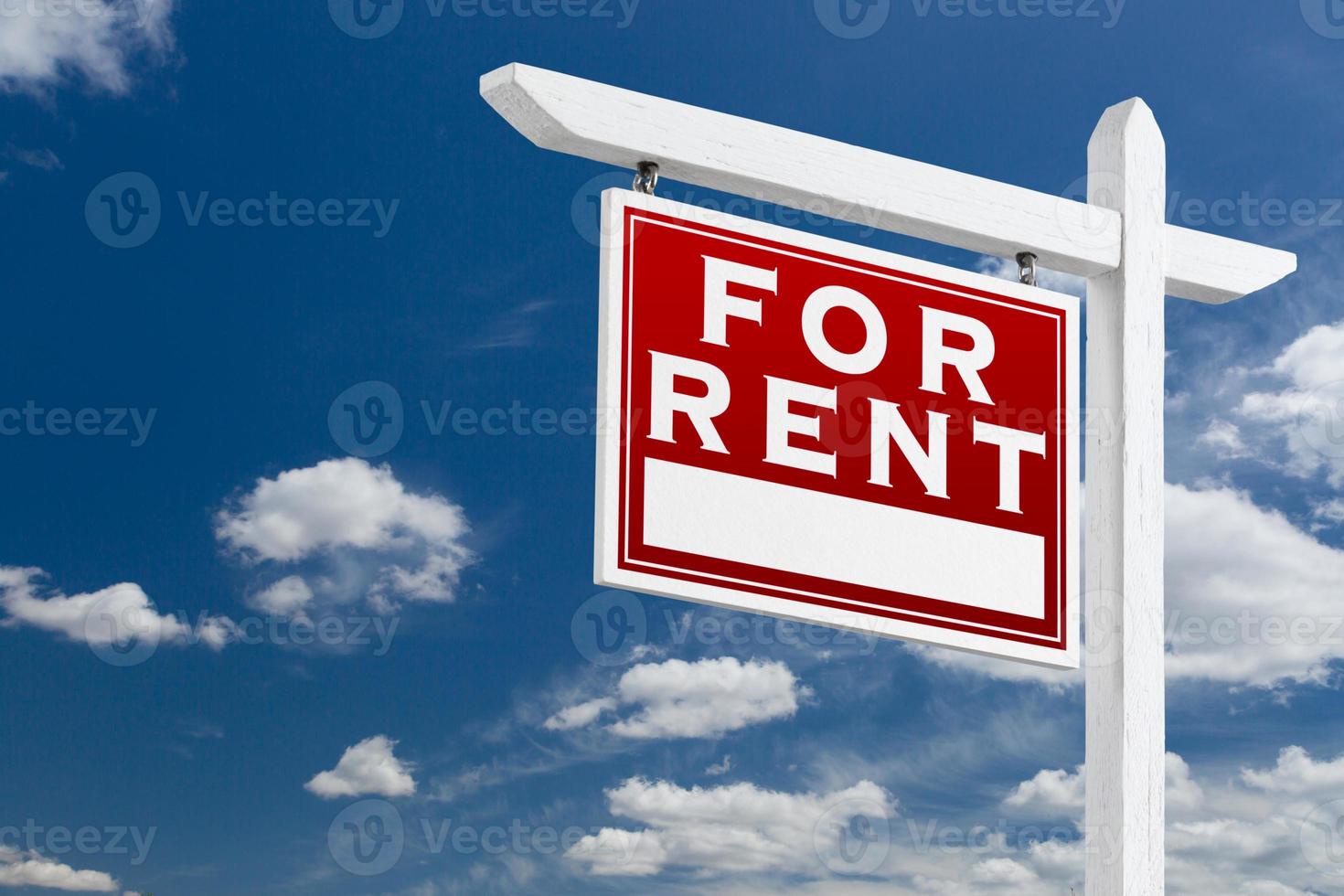 Left Facing For Rent Real Estate Sign Over Blue Sky and Clouds With Room For Your Text. photo