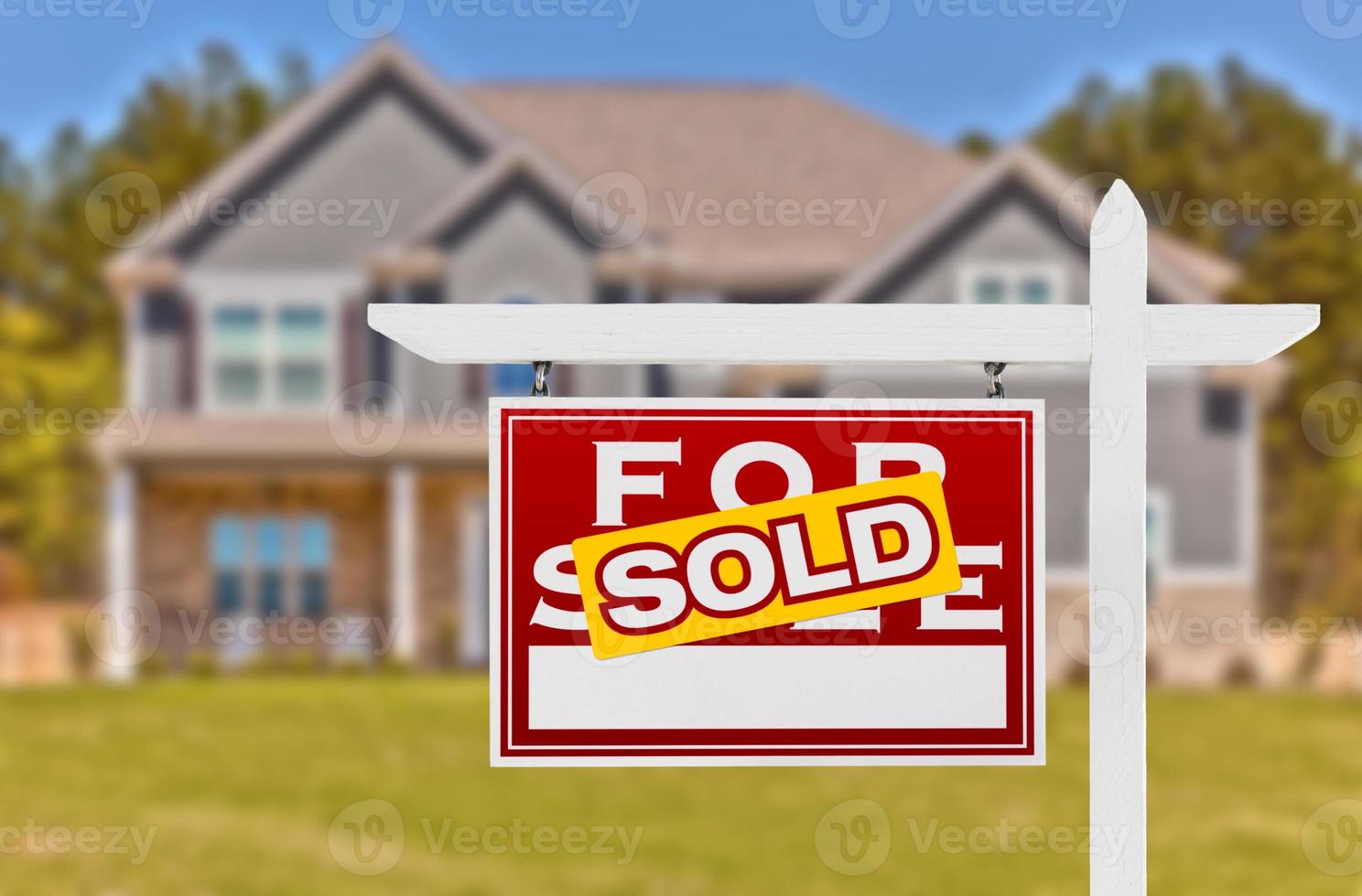 Sold Home For Sale Real Estate Sign in Front of Beautiful New House photo