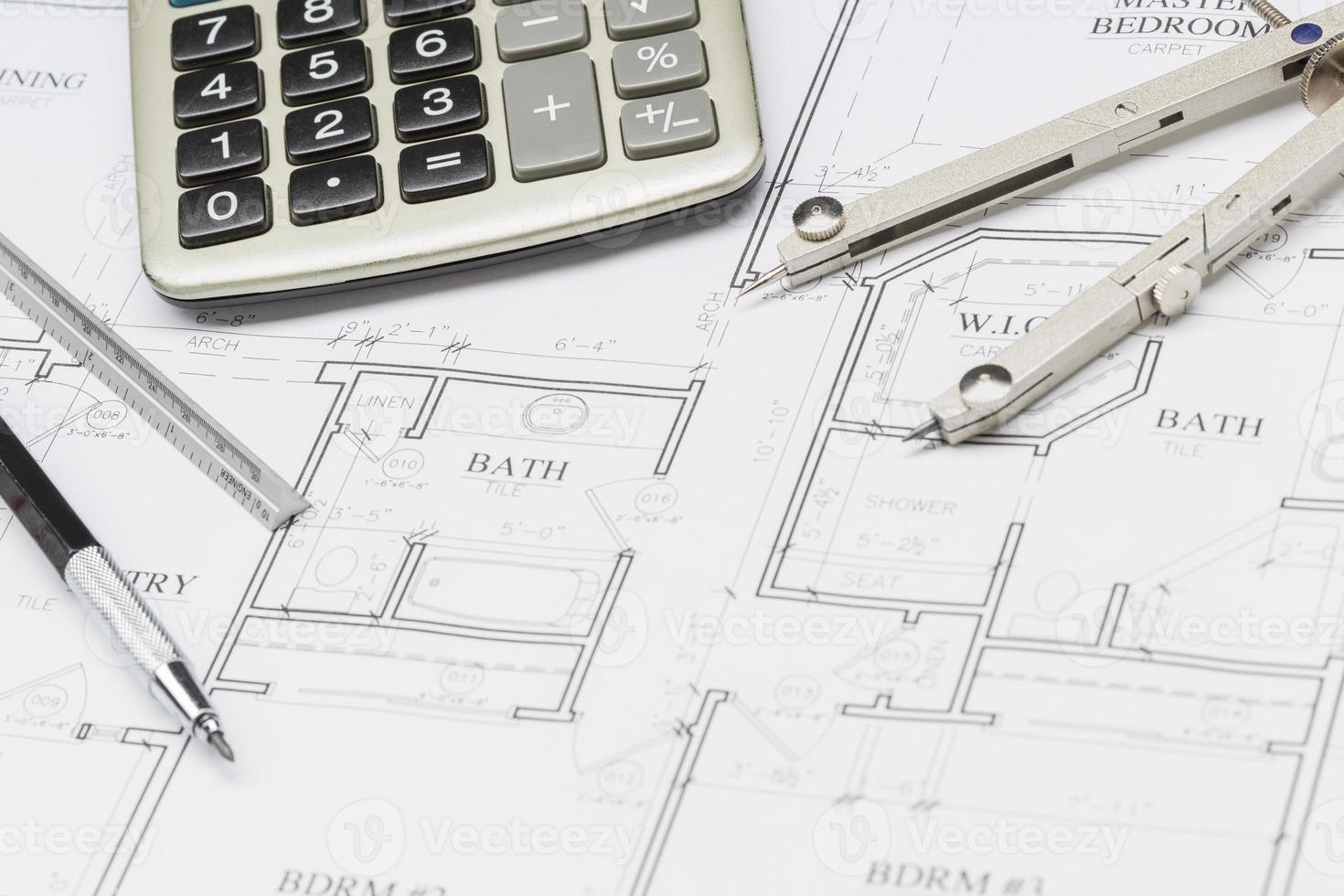 Pencil, Ruler, Compass and Calculator Resting on House Plans photo
