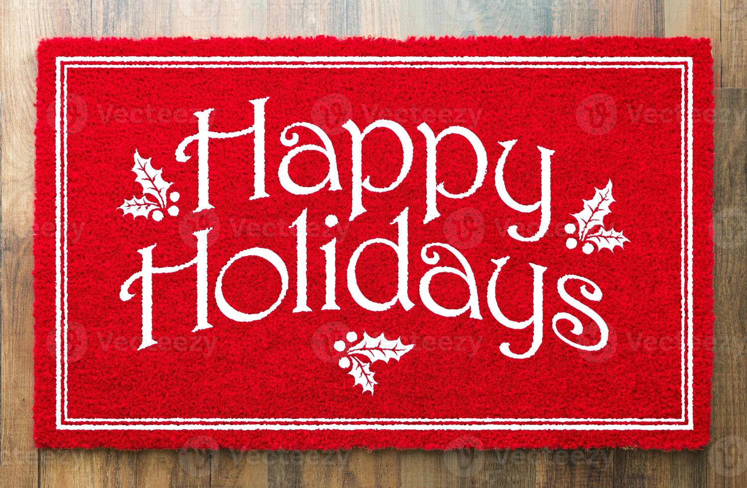 Happy Holidays Christmas Red Welcome Mat On Wood Floor Background photo