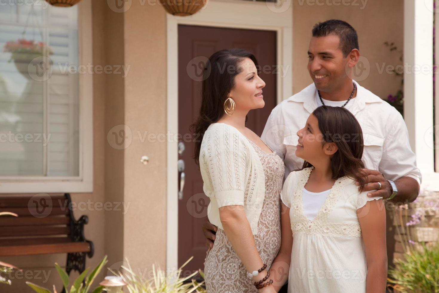 Small Hispanic Family in Front of Their Home photo