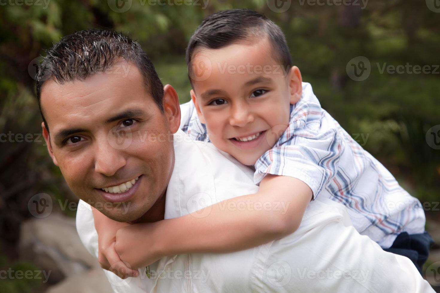 Hispanic Father and Son Having Fun in the Park photo