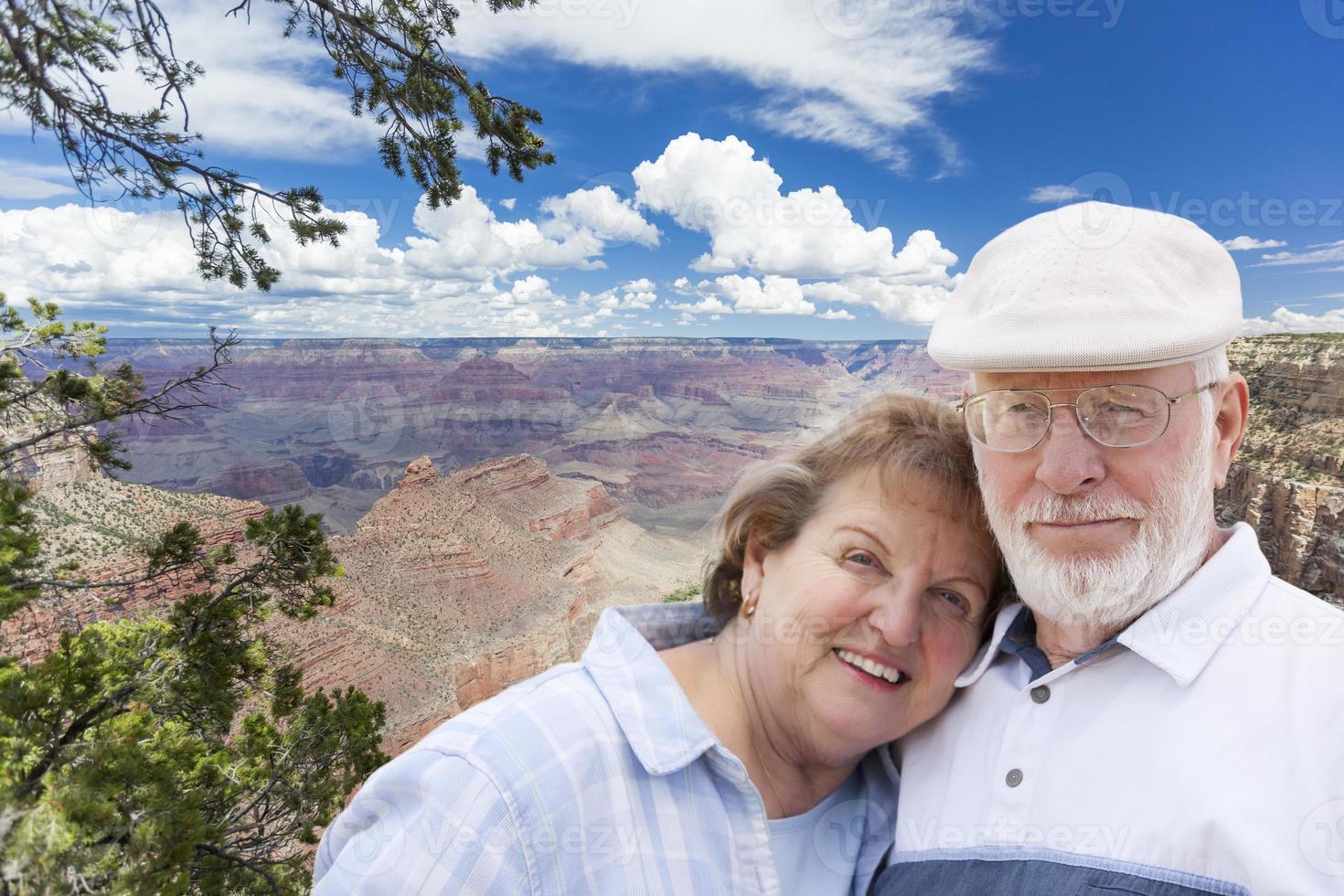 Happy Senior Couple Posing on Edge of The Grand Canyon photo