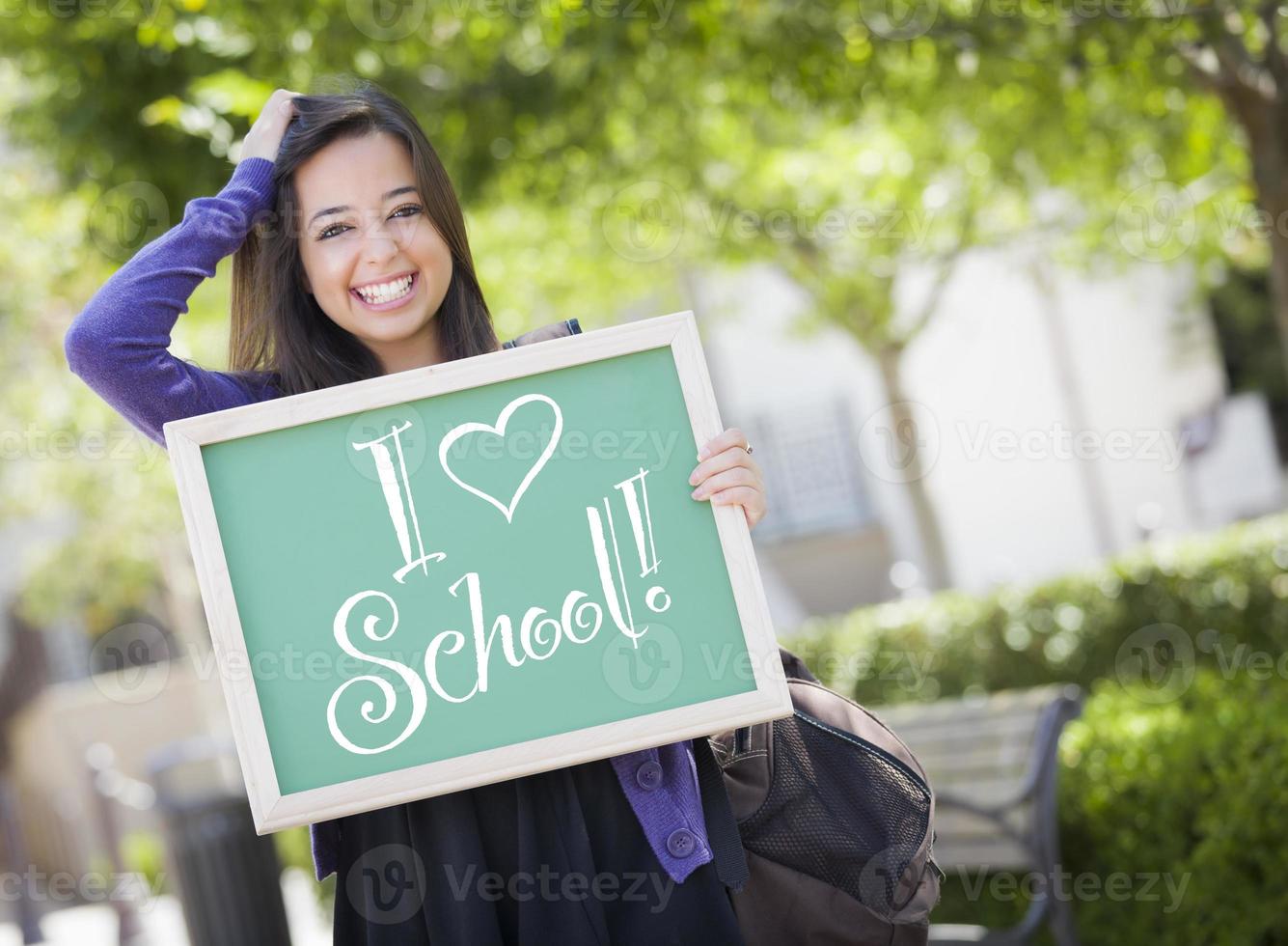 Mixed Race Female Student Holding Chalkboard With I Love School photo