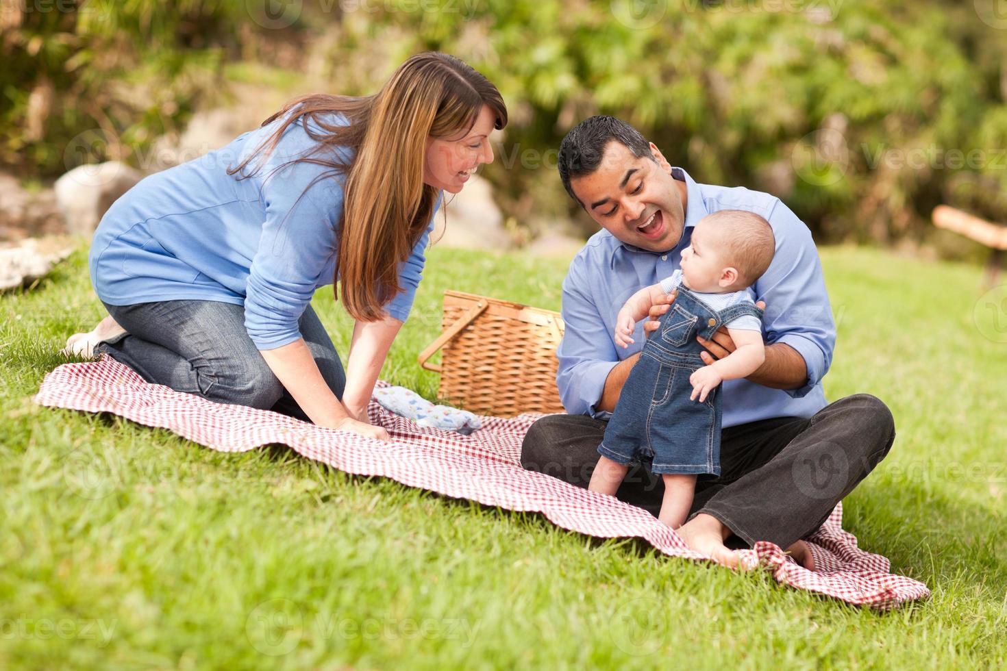 Happy Mixed Race Family Playing In The Park photo