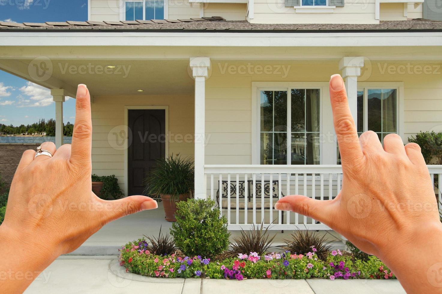 Female Hands Framing Beautiful House photo