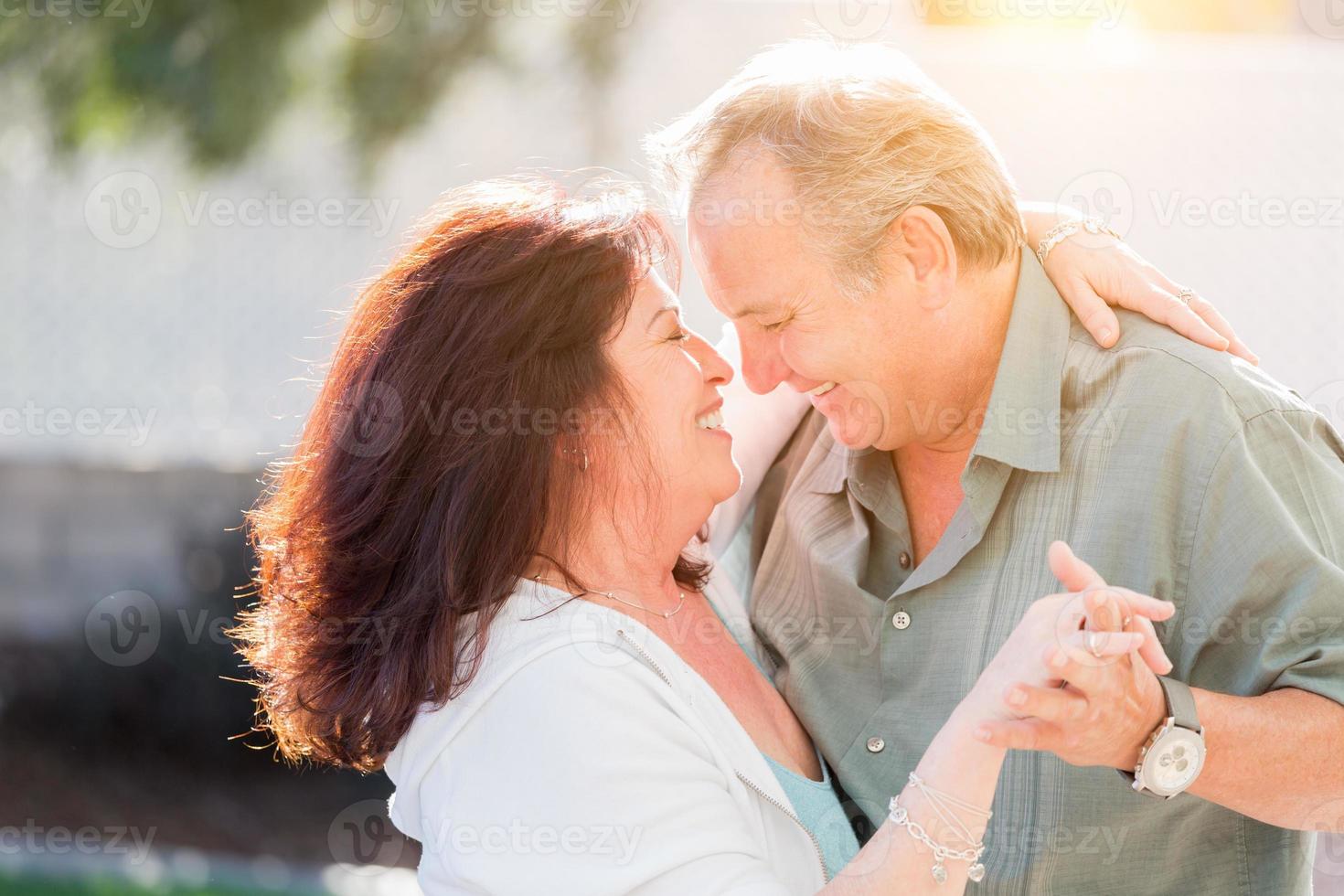 Middle Aged Couple Enjoy A Romantic Slow Dance Outside photo