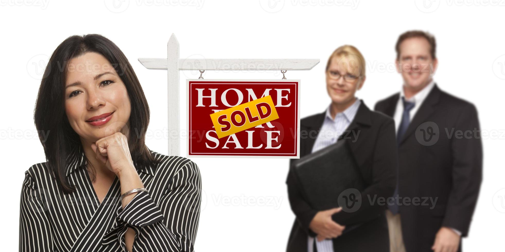 Mixed Race People with Sold Real Estate Sign Isolated photo