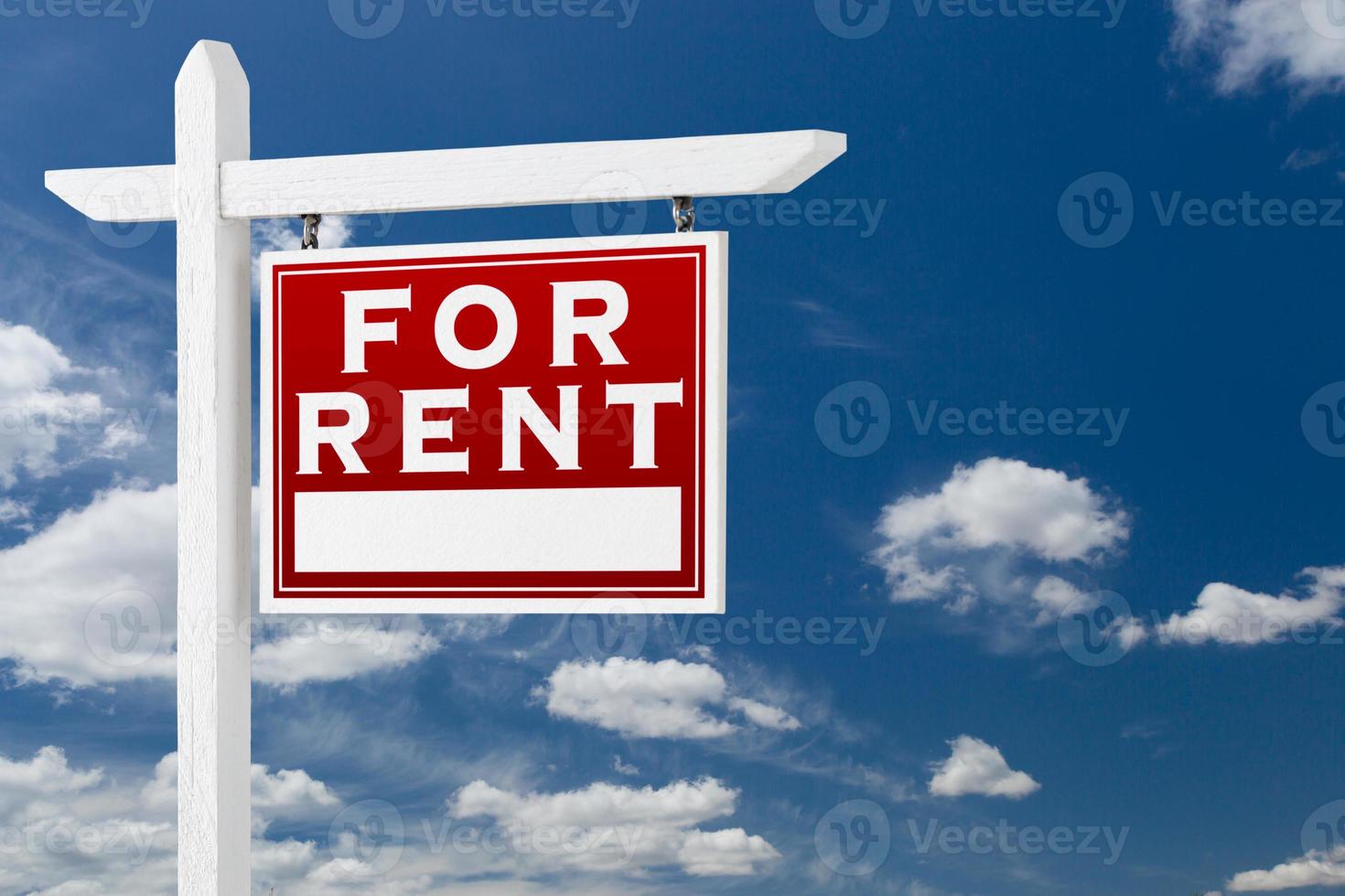 Right Facing For Rent Real Estate Sign Over Blue Sky and Clouds With Room For Your Text. photo