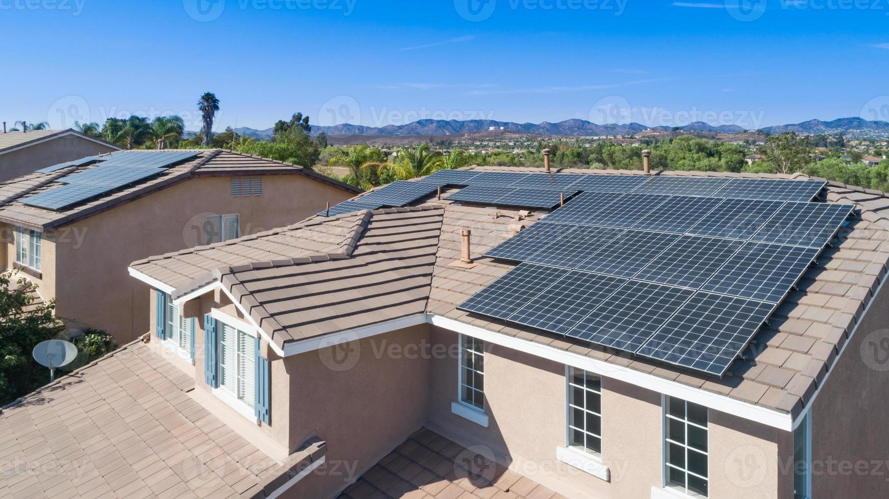 Solar Panels Installed on Roof of Large House photo