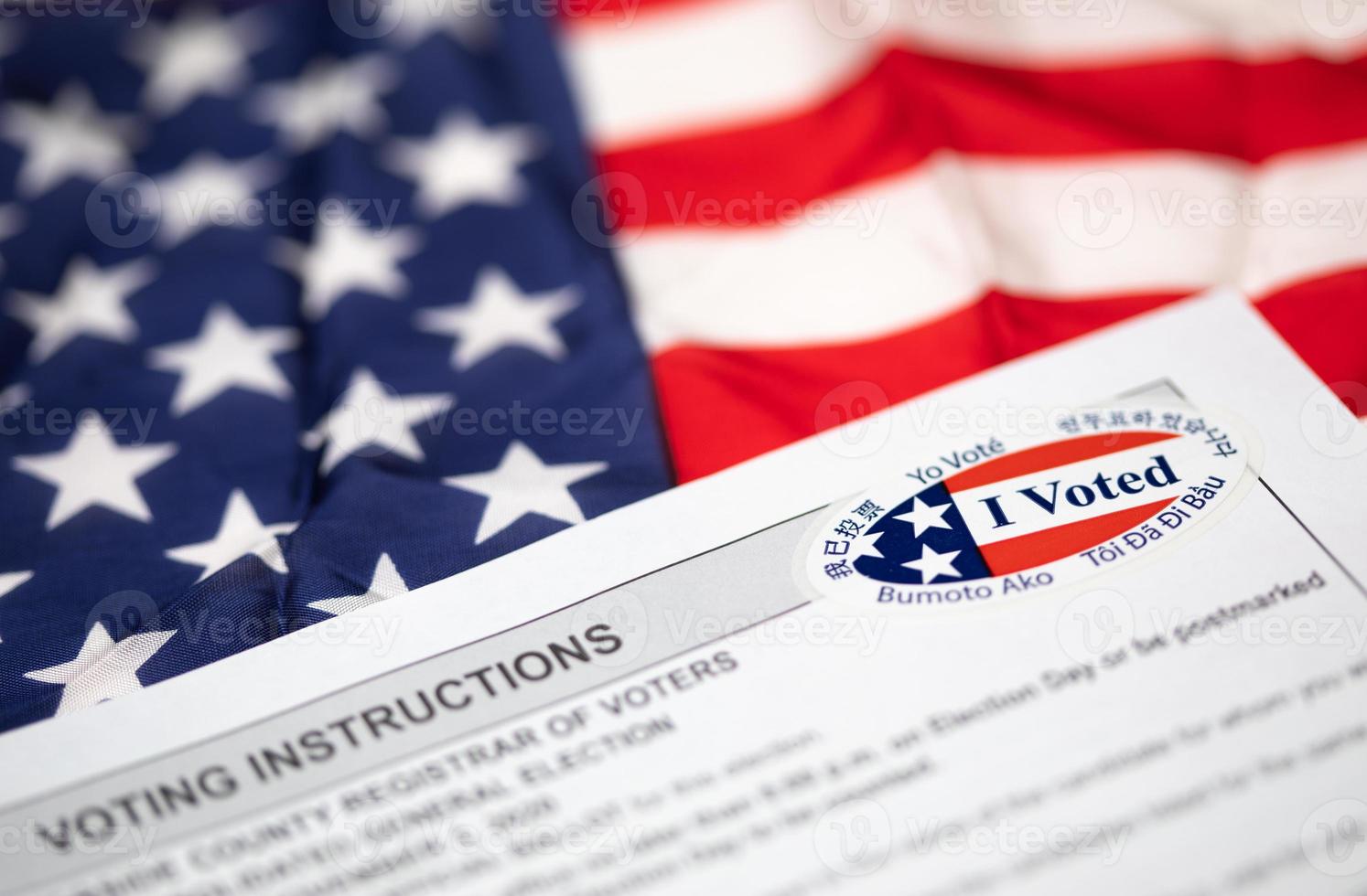 Voting Instructions with I Voted Sticker Laying on American Flag photo