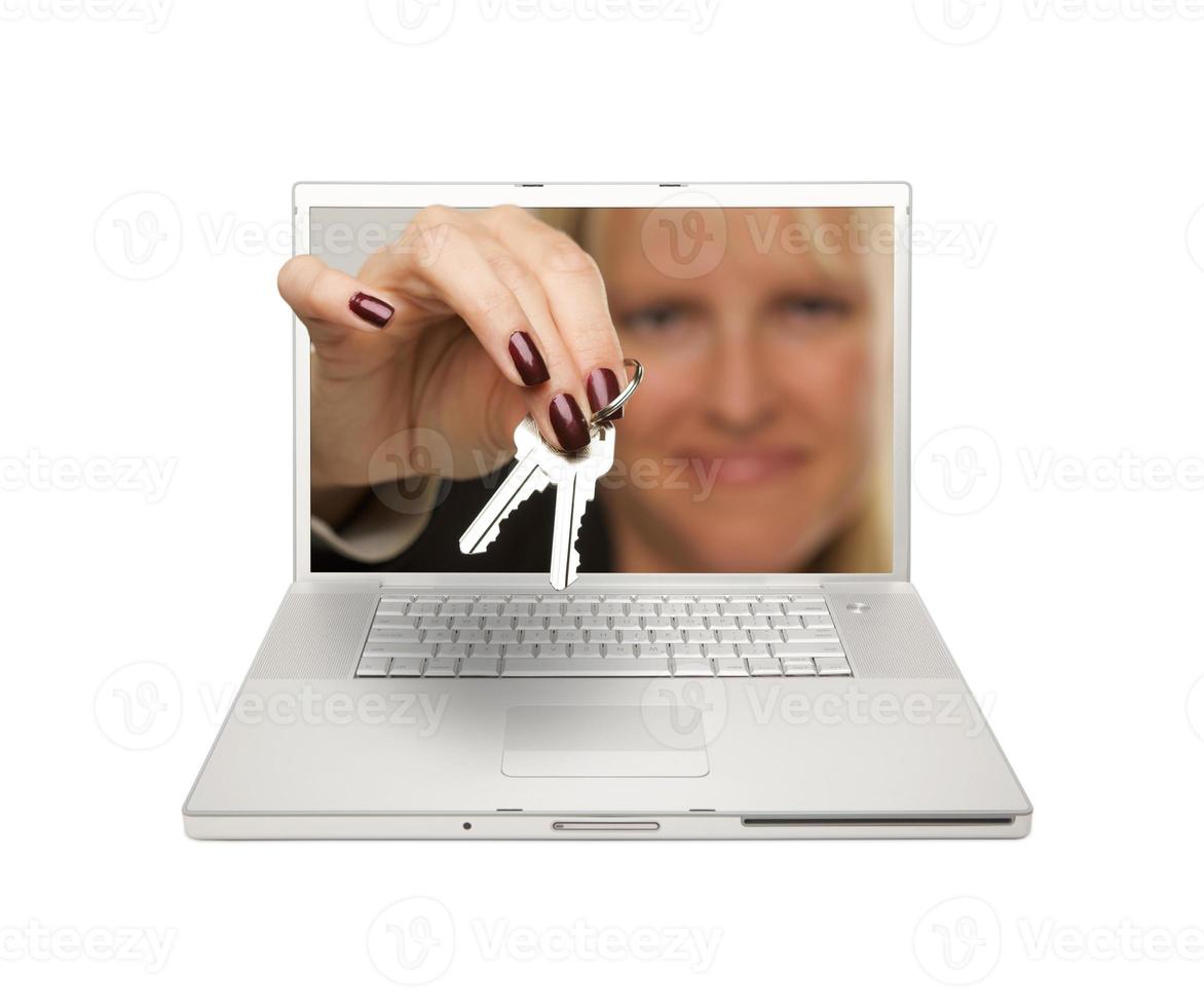 Woman Handing House Keys Through Laptop Screen photo