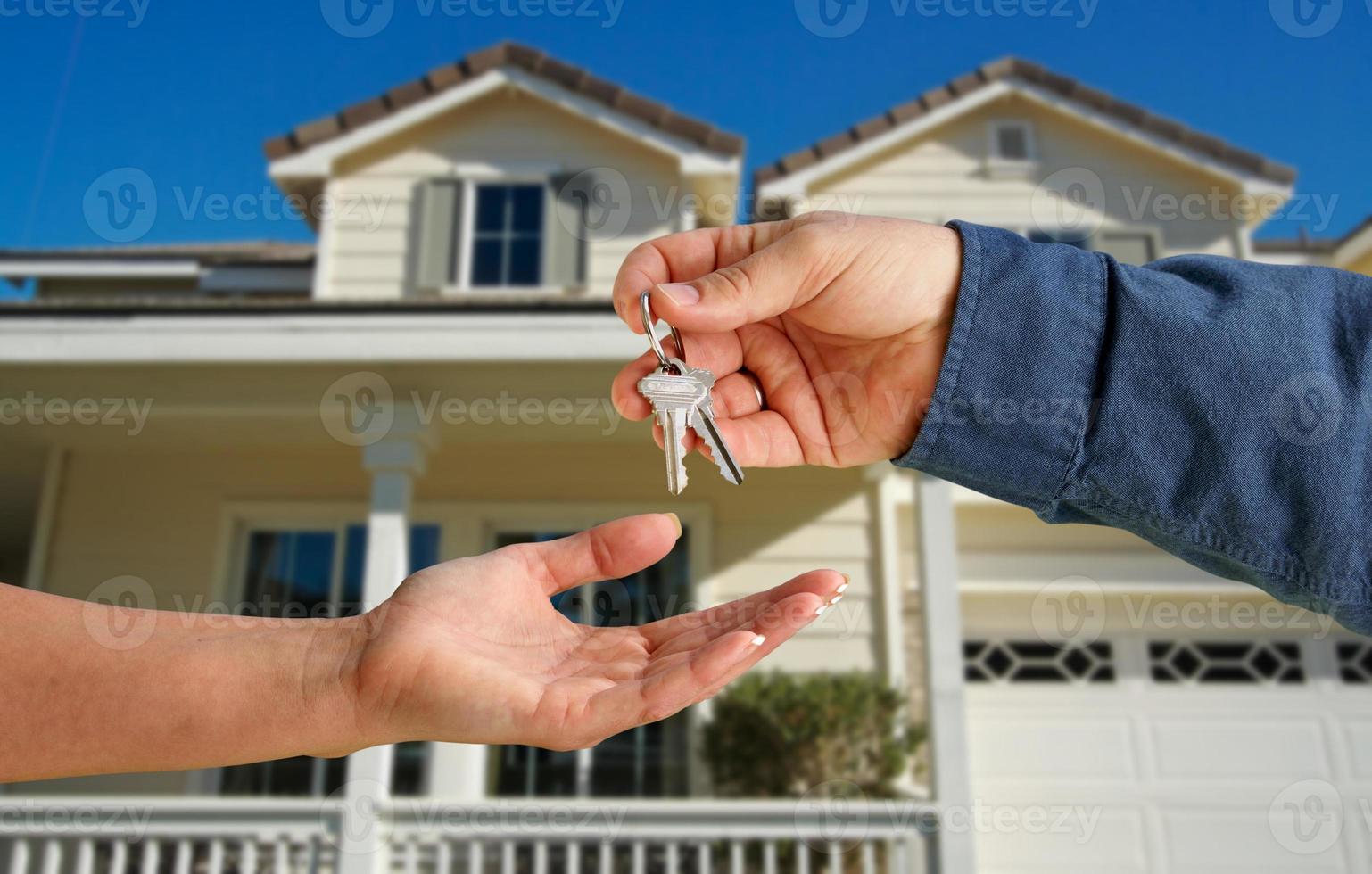 Handing Over the House Keys in Front of New Home photo