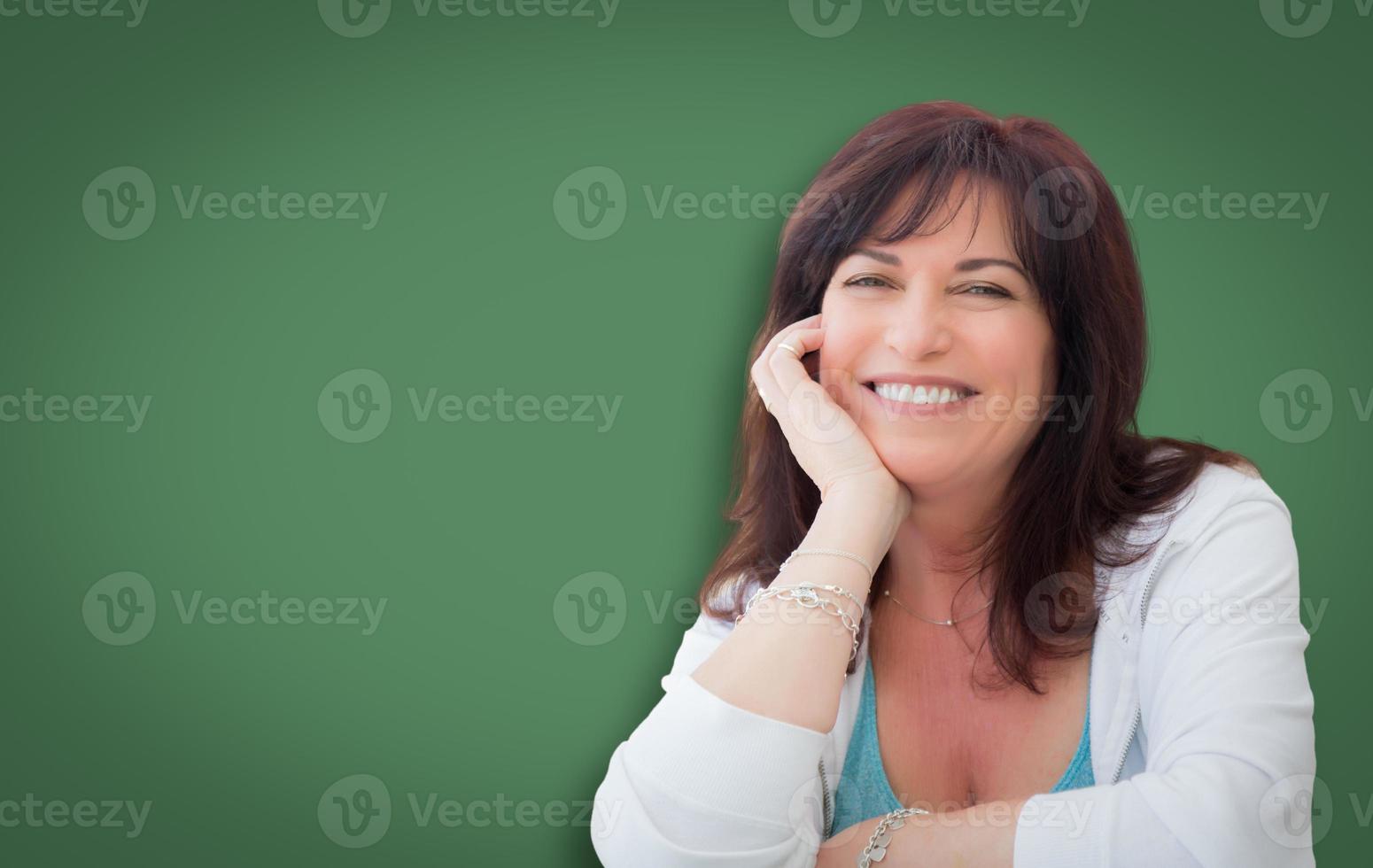 Attractive Middle Aged Woman Portrait In Front of Green Chalkboard photo