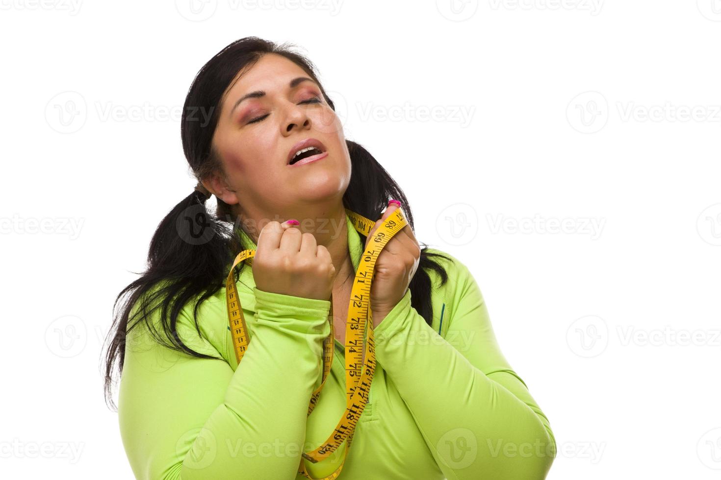 Frustrated Hispanic Woman with Tape Measure photo