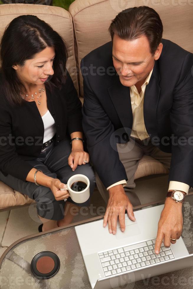 Man and Woman Using Laptop with Coffee photo