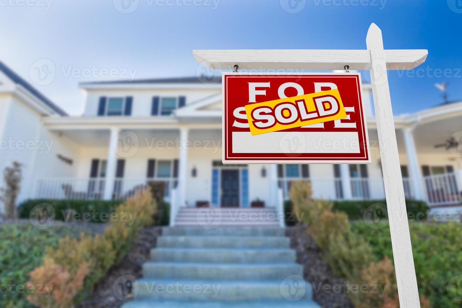 Left Facing Sold For Sale Real Estate Sign In Front of House. photo