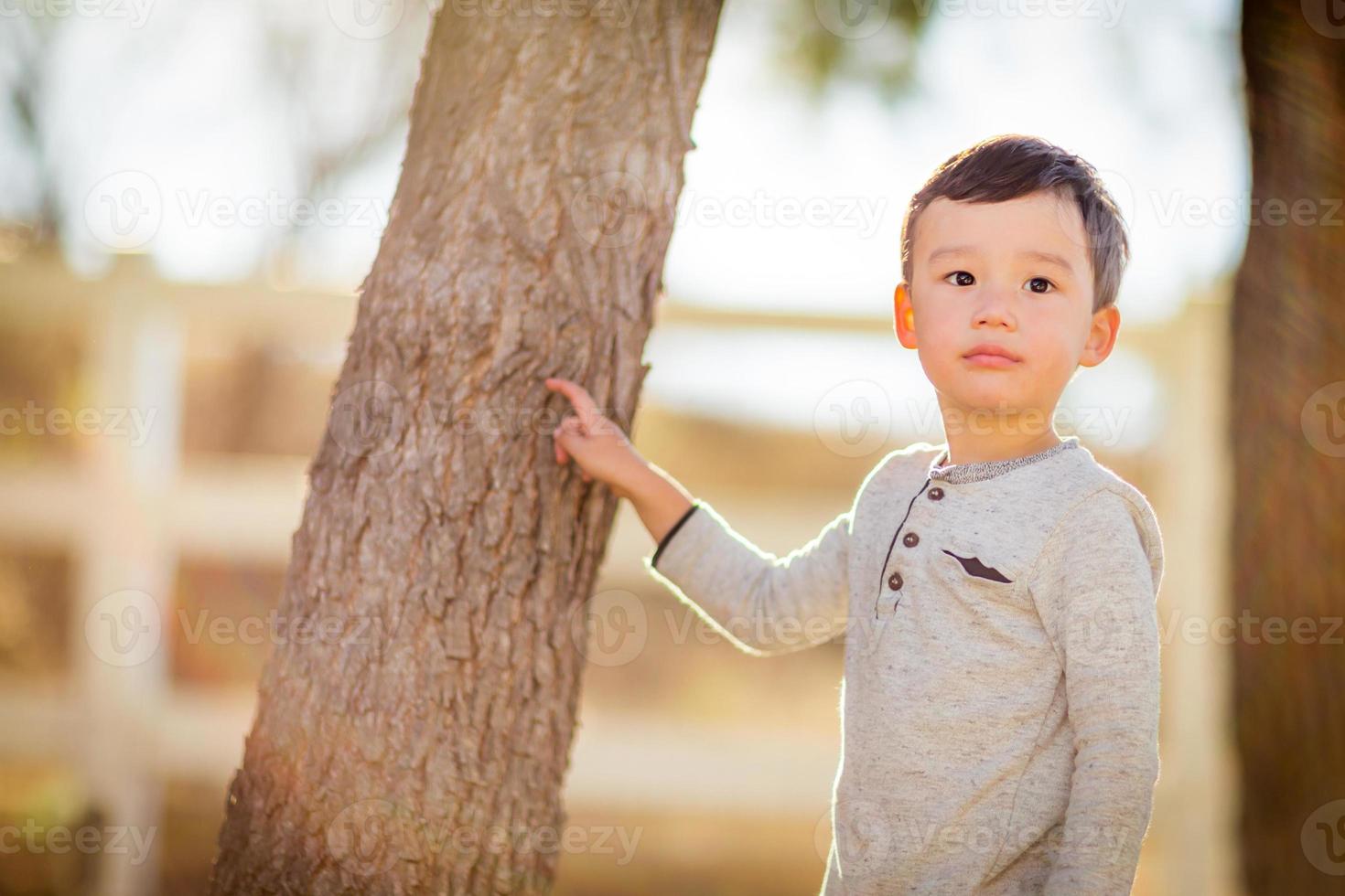 Outdoor portrait of a mixed race Chinese and Caucasian boy. photo