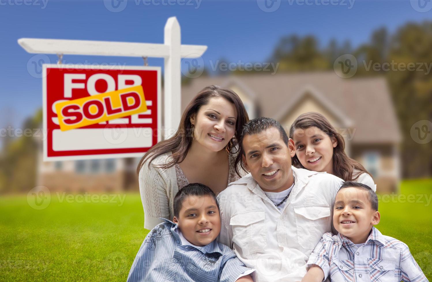 Hispanic Family, New Home and Sold Real Estate Sign photo