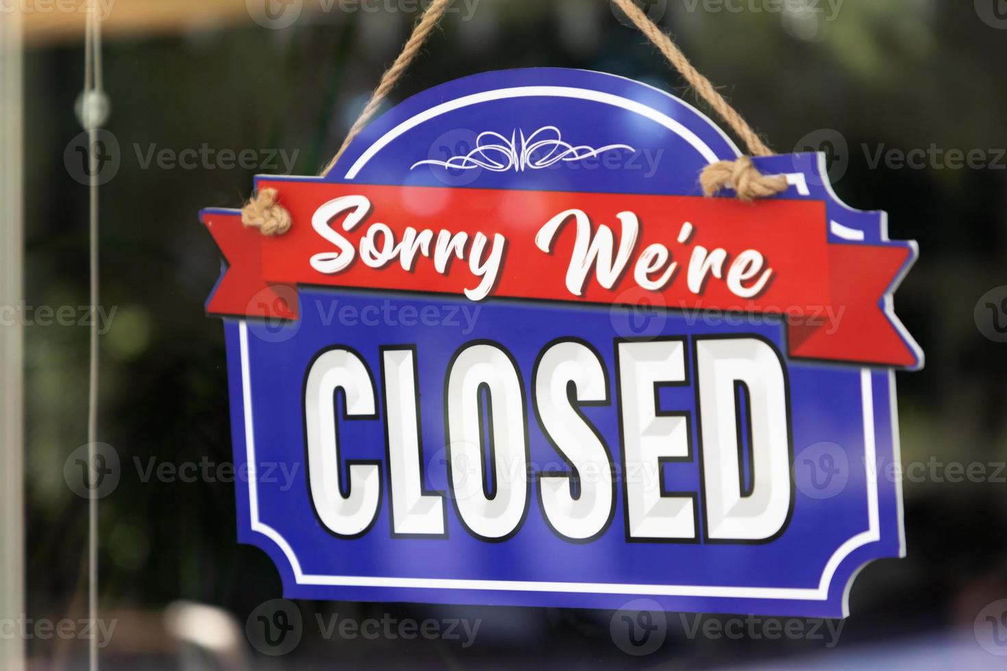 Storefront Closed Sign Through Window photo