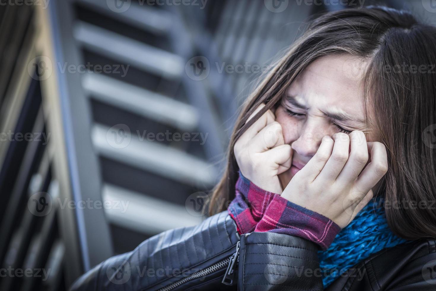 Young Crying Teen Aged Girl on Staircase photo