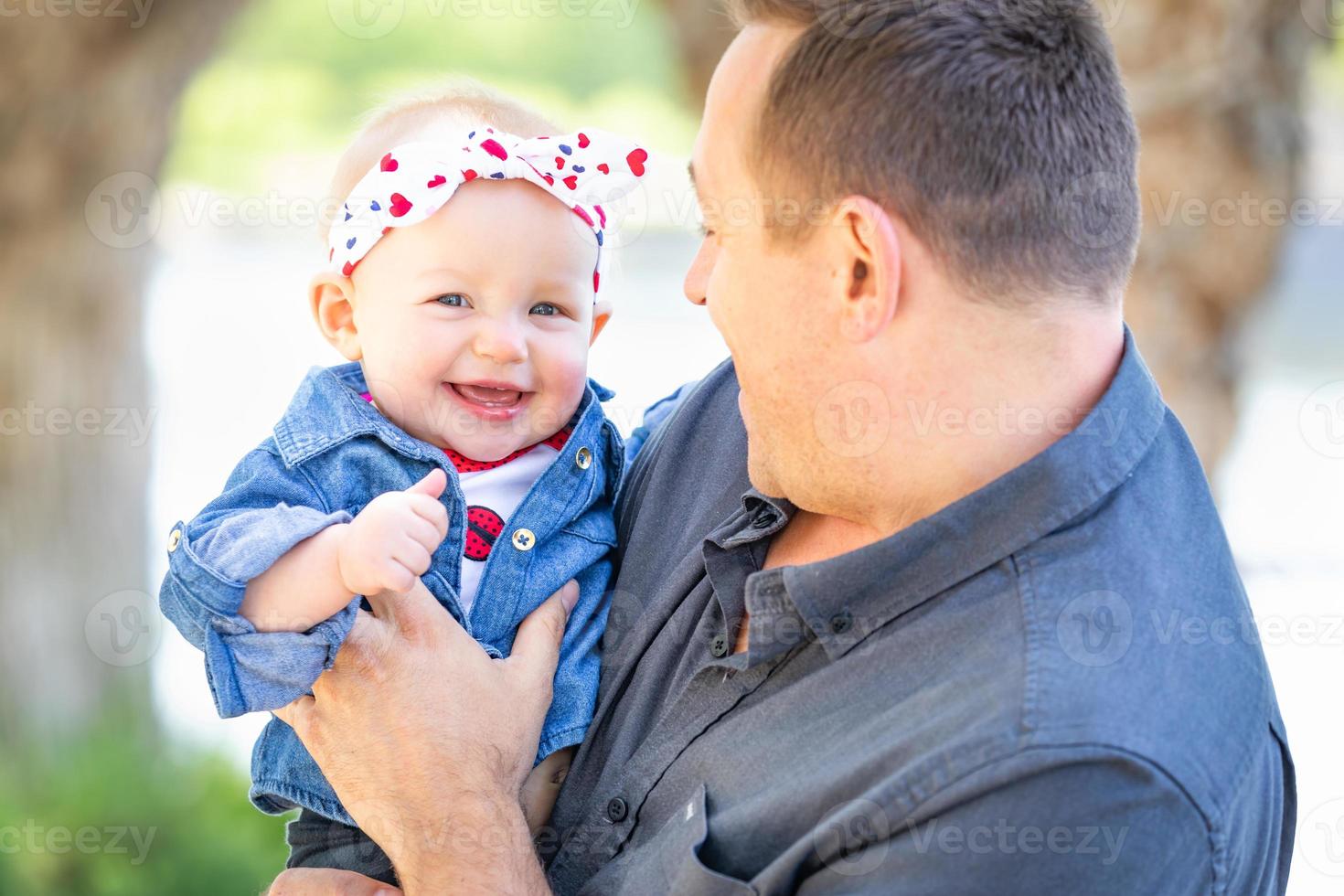 Young Caucasian Father and Baby Girl At The Park photo