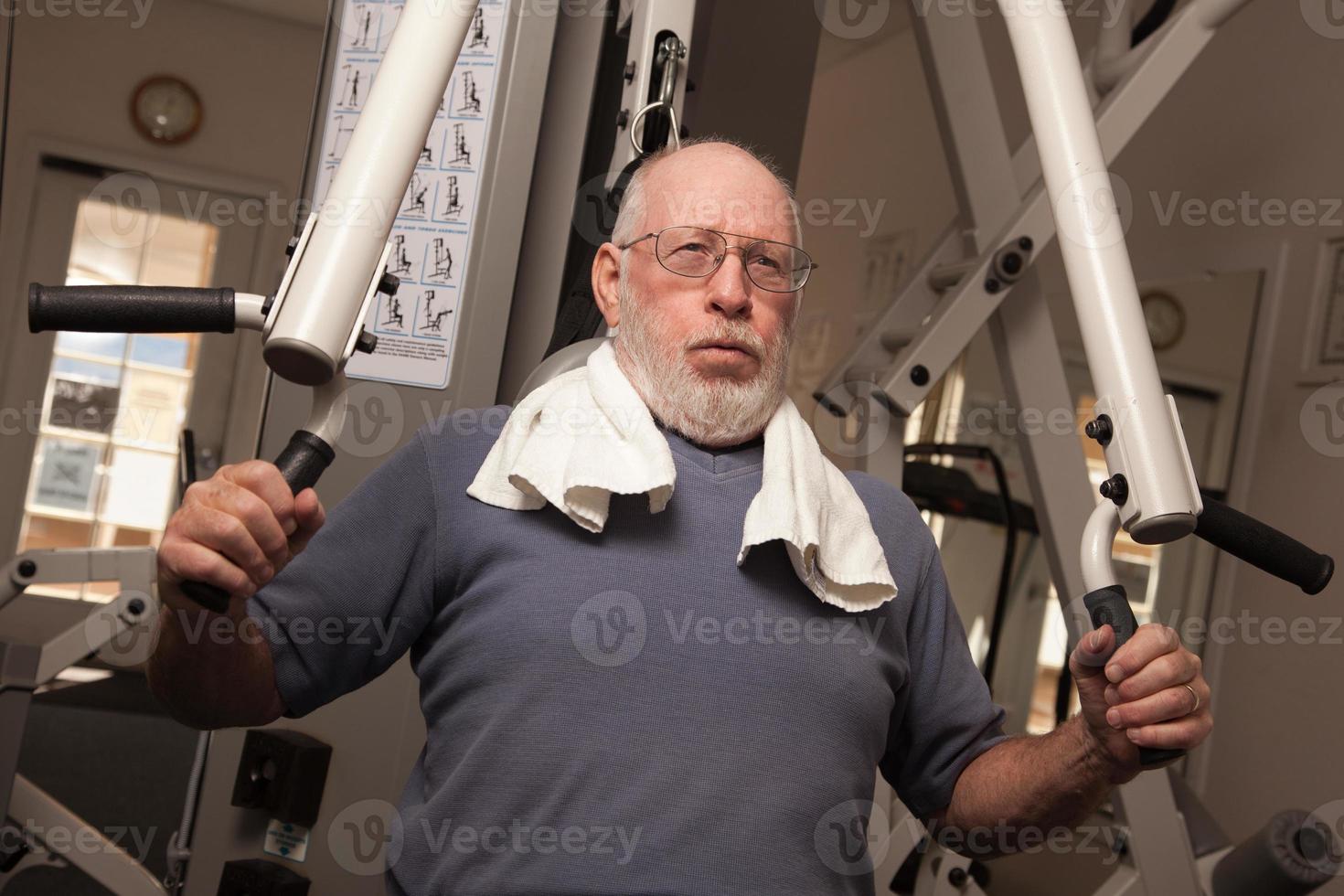 Elderly Adult Man Working Out in the Gym. photo