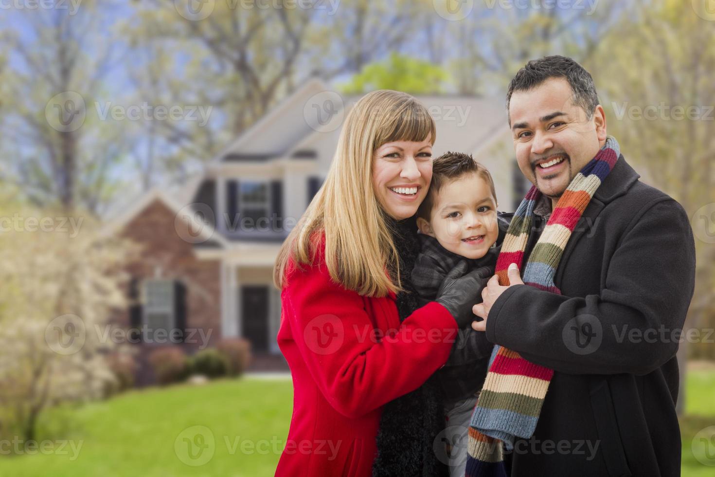 Happy Mixed Race Family in Front of House photo