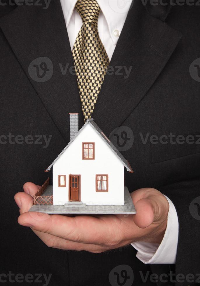 Businessman Holding House photo