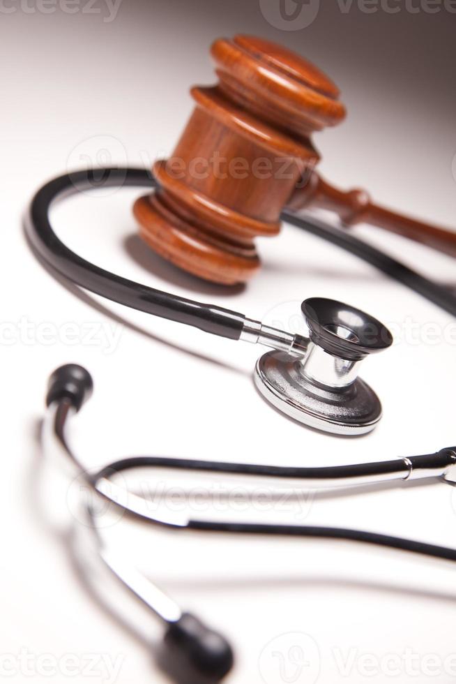 Gavel and Stethoscope on Gradated Background photo