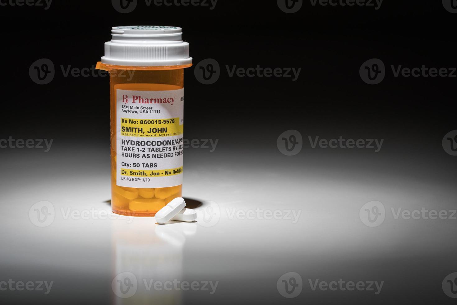 Hydrocodone Pills and Prescription Bottle with Non Proprietary Label. No model release required - contains fictitious information. photo