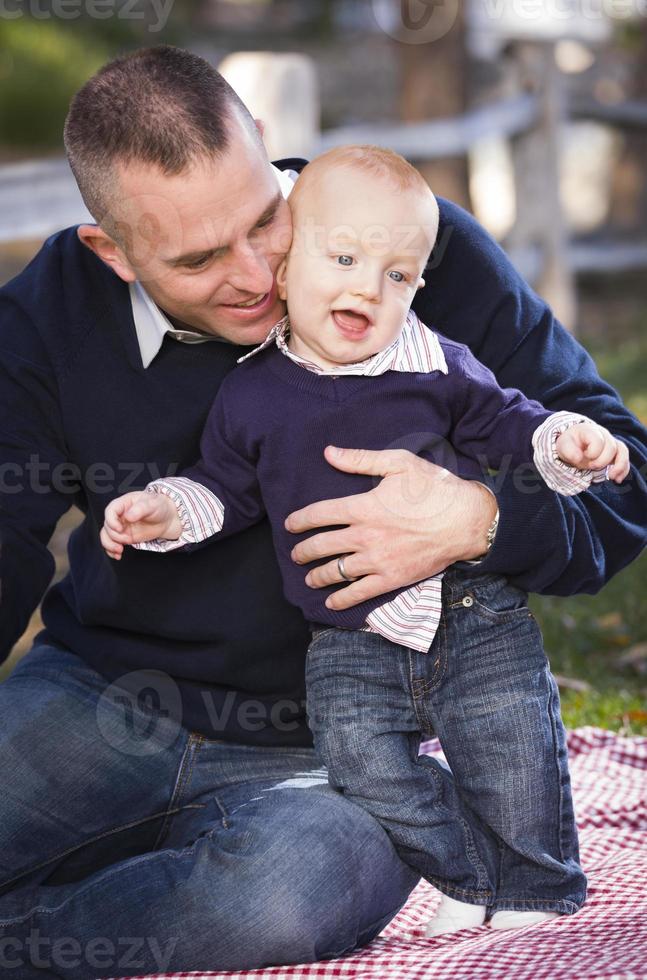 Infant Boy and Young Military Father Play in the Park photo