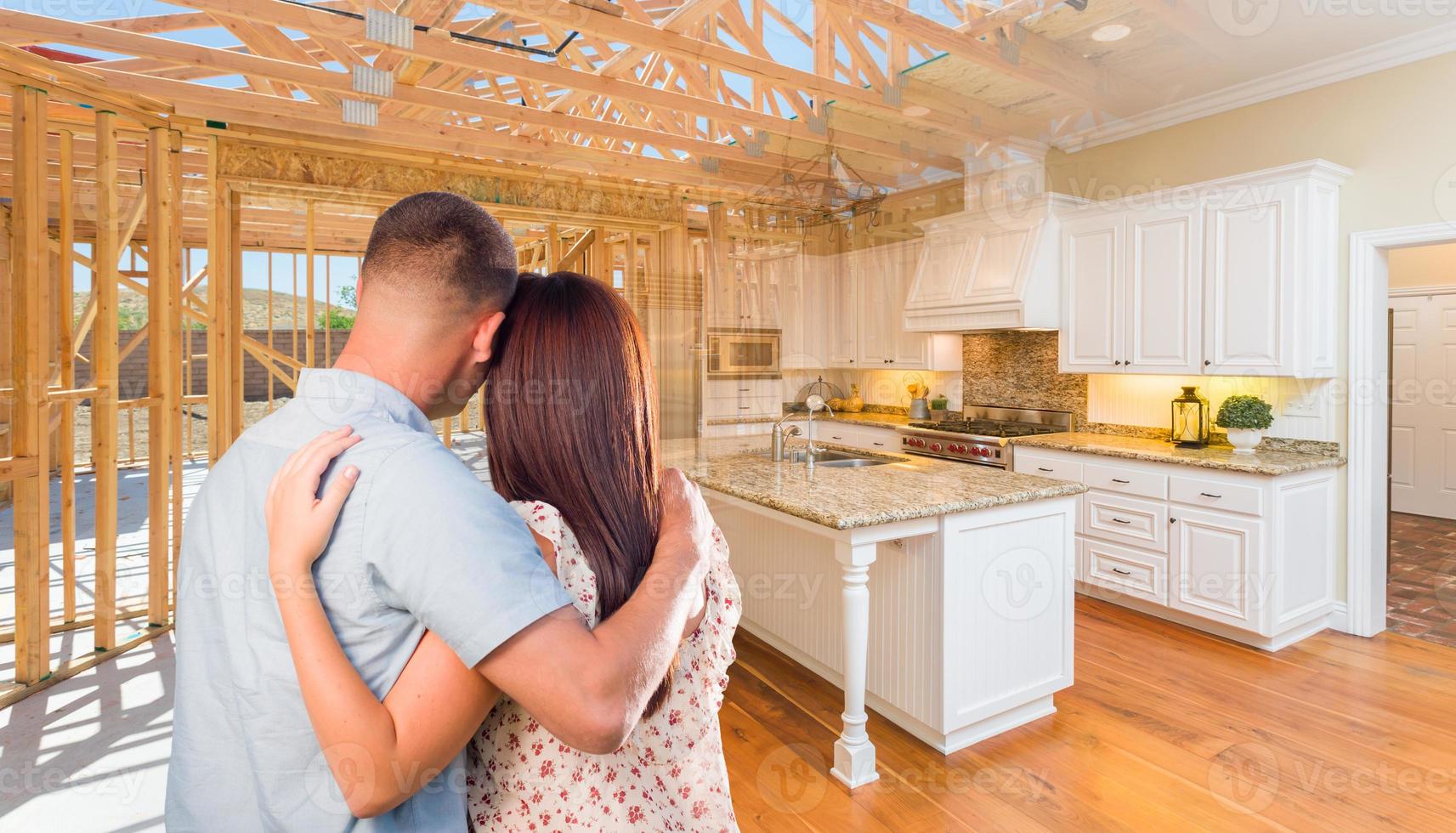 Young Military Couple Facing House Construction Framing Gradating Into Finished Kitchen Build photo