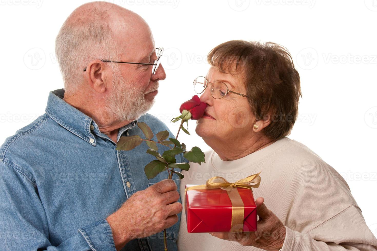 Happy Senior Couple with Gift and Red Rose photo