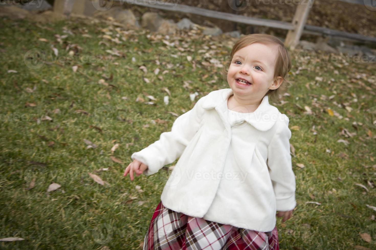 Adorable Baby Girl Playing in Park photo