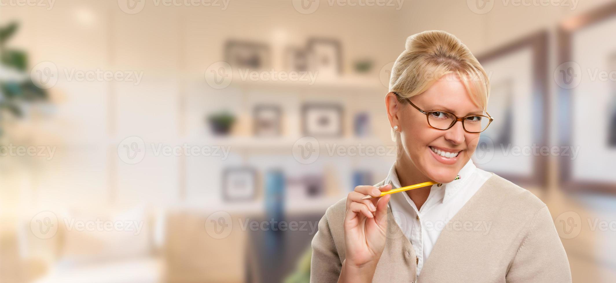 Beautiful Expressive Student or Businesswoman with Pencil in Office. photo