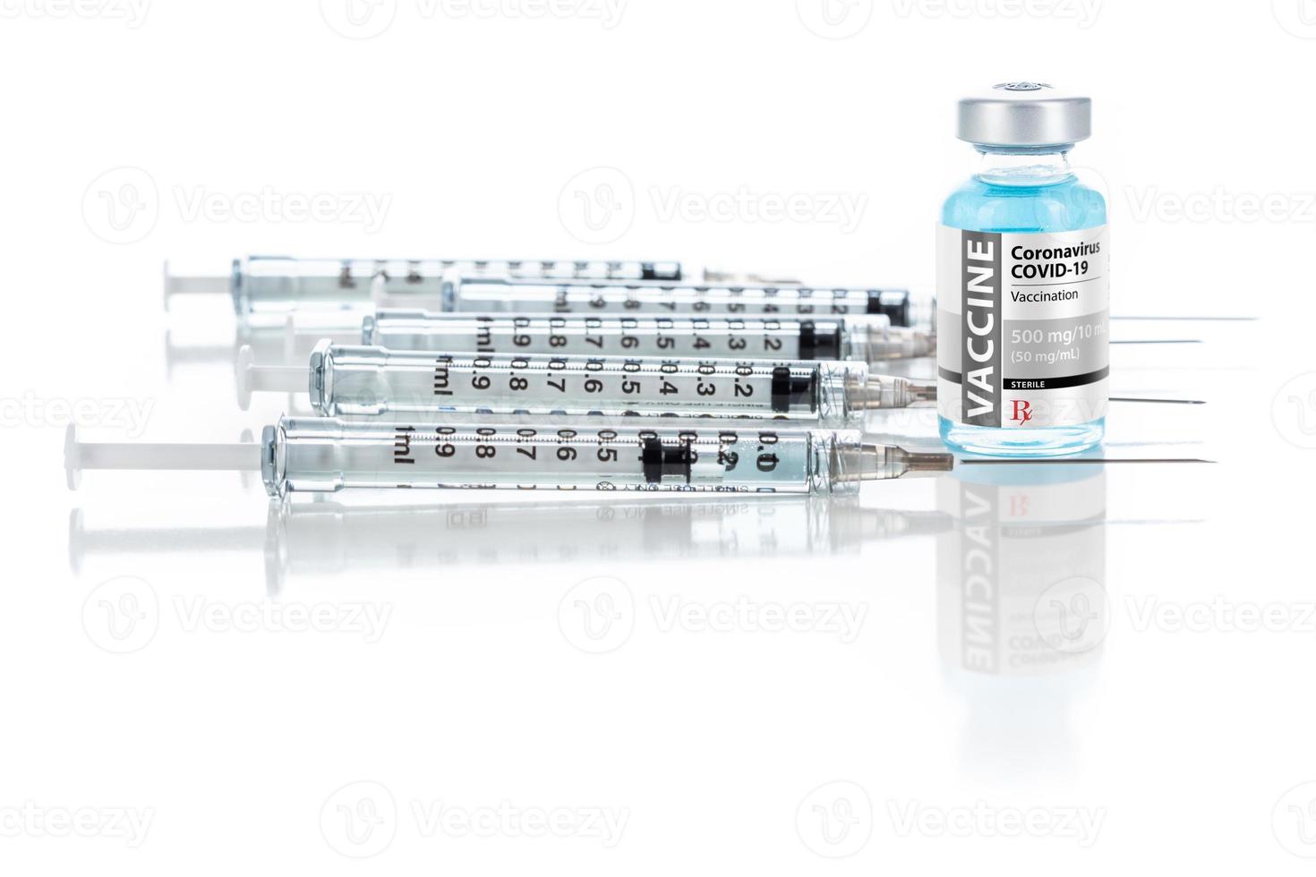 Coronavirus COVID-19 Vaccine Vial and Several Syringes On Reflective Surface photo