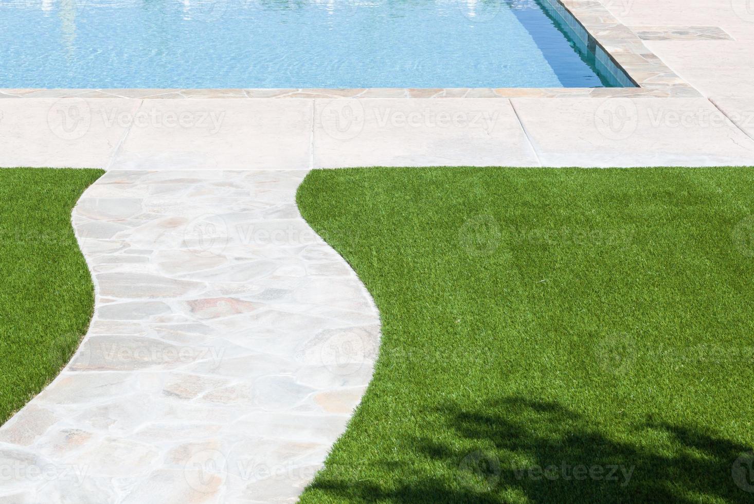 New Artificial Grass Installed Near Walkway and Pool. photo