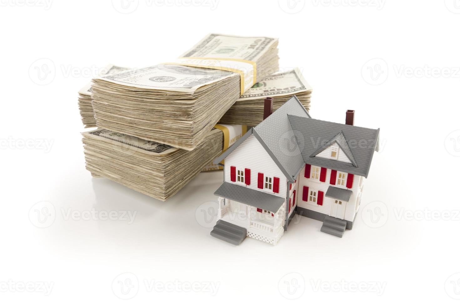 Small House with Stacks of Hundred Dollar Bills photo